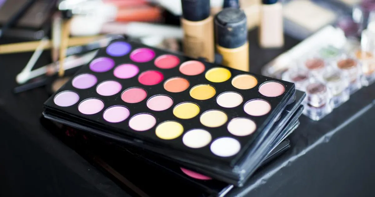 An open makeup palette with coordinating shades and brushes