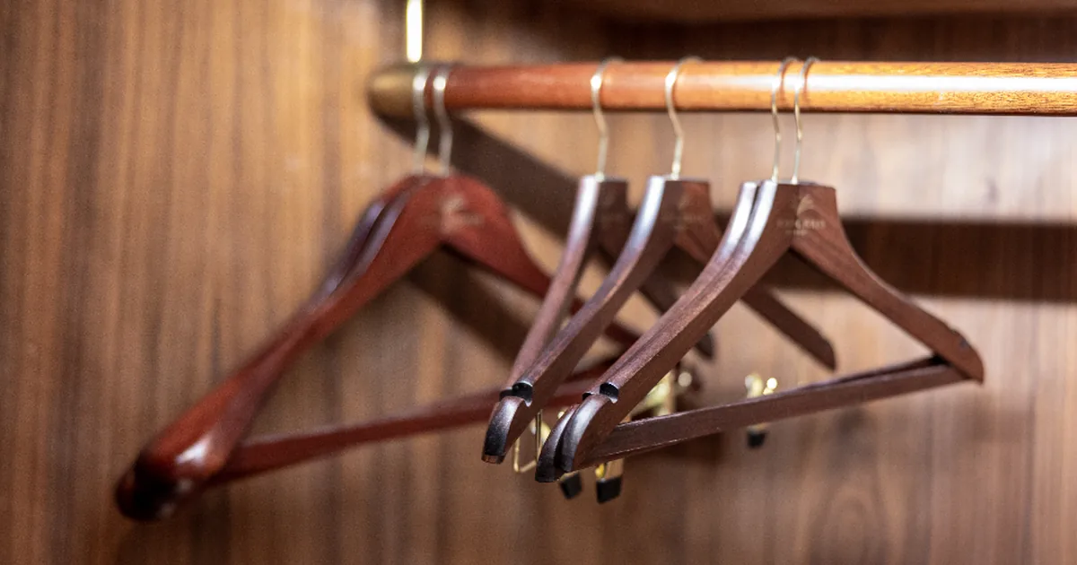A rail of wooden hangers suggesting a coordinated colour wardrobe
